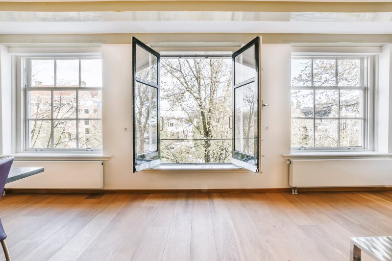 A room with an open vacuum glass window